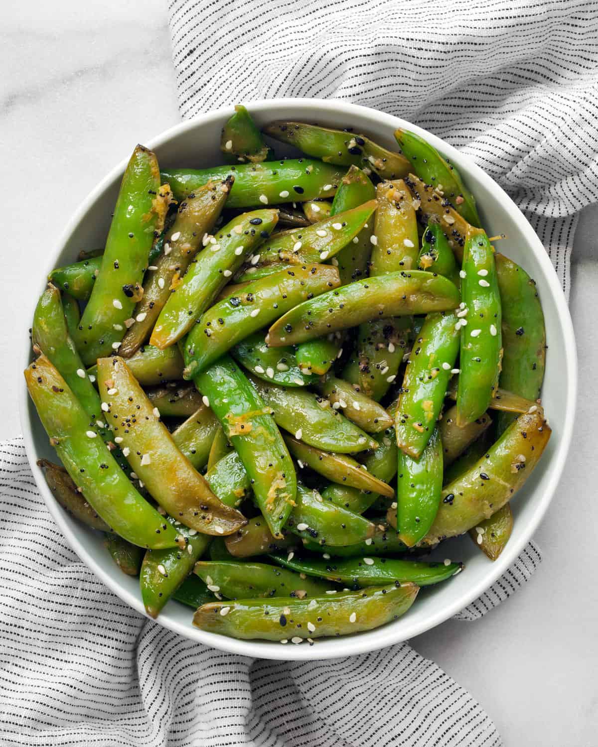 Sautéed snap peas in a bowl.