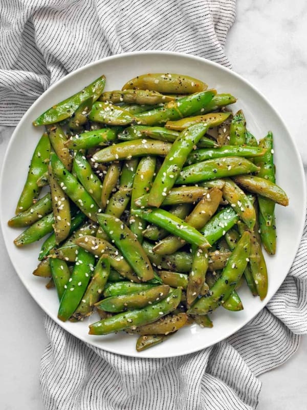 Sautéed sugar snap peas on a plate.