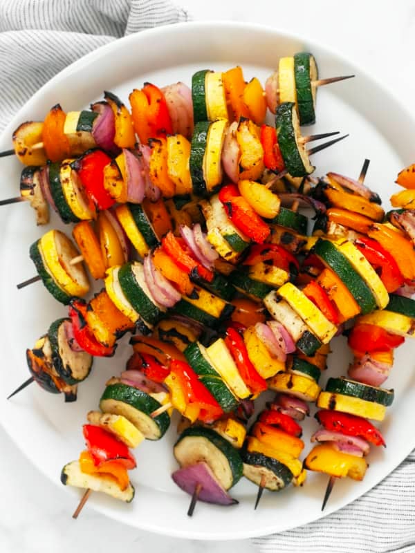 Balsamic grilled vegetable skewers on a plate.