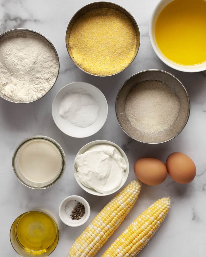 Ingredients including flour, cornmeal, corn, melted butter, eggs, sugar, baking soda, baking powder and salt.