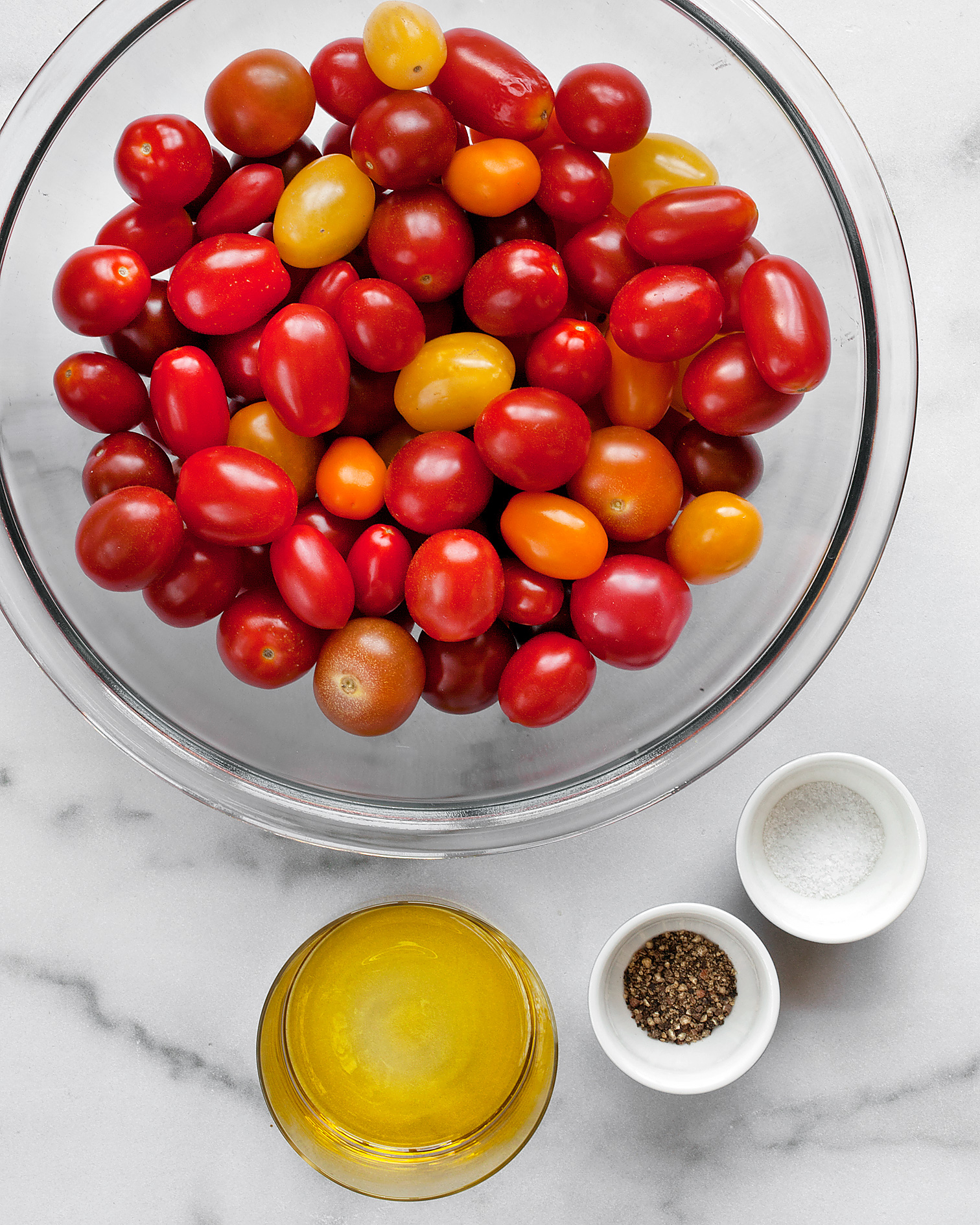 Ingredients including tomatoes, olive oil, salt and pepper.