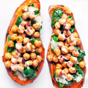 Baked sweet potatoes stuffed with crispy chickpeas and spinach.