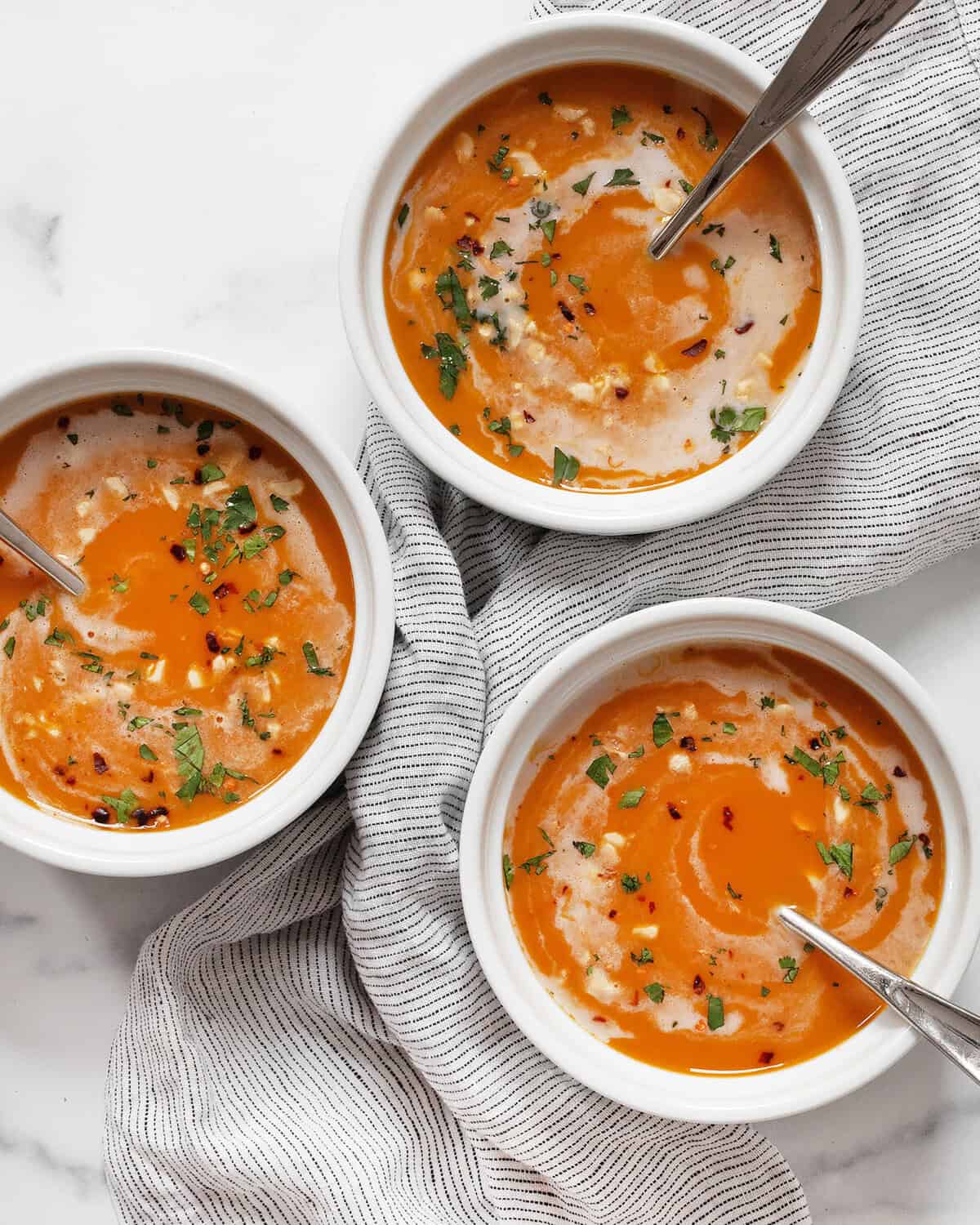 Three bowls of slow-cooker butternut squash soup.
