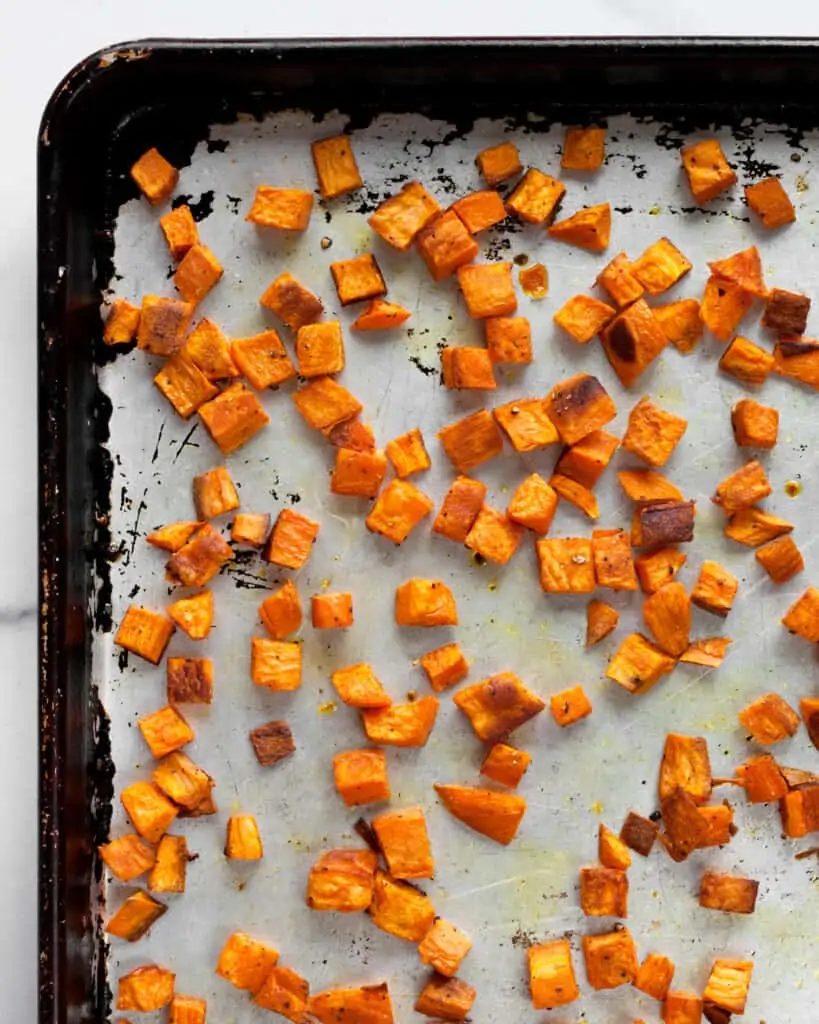Dice roasted sweet potatoes on sheet pan