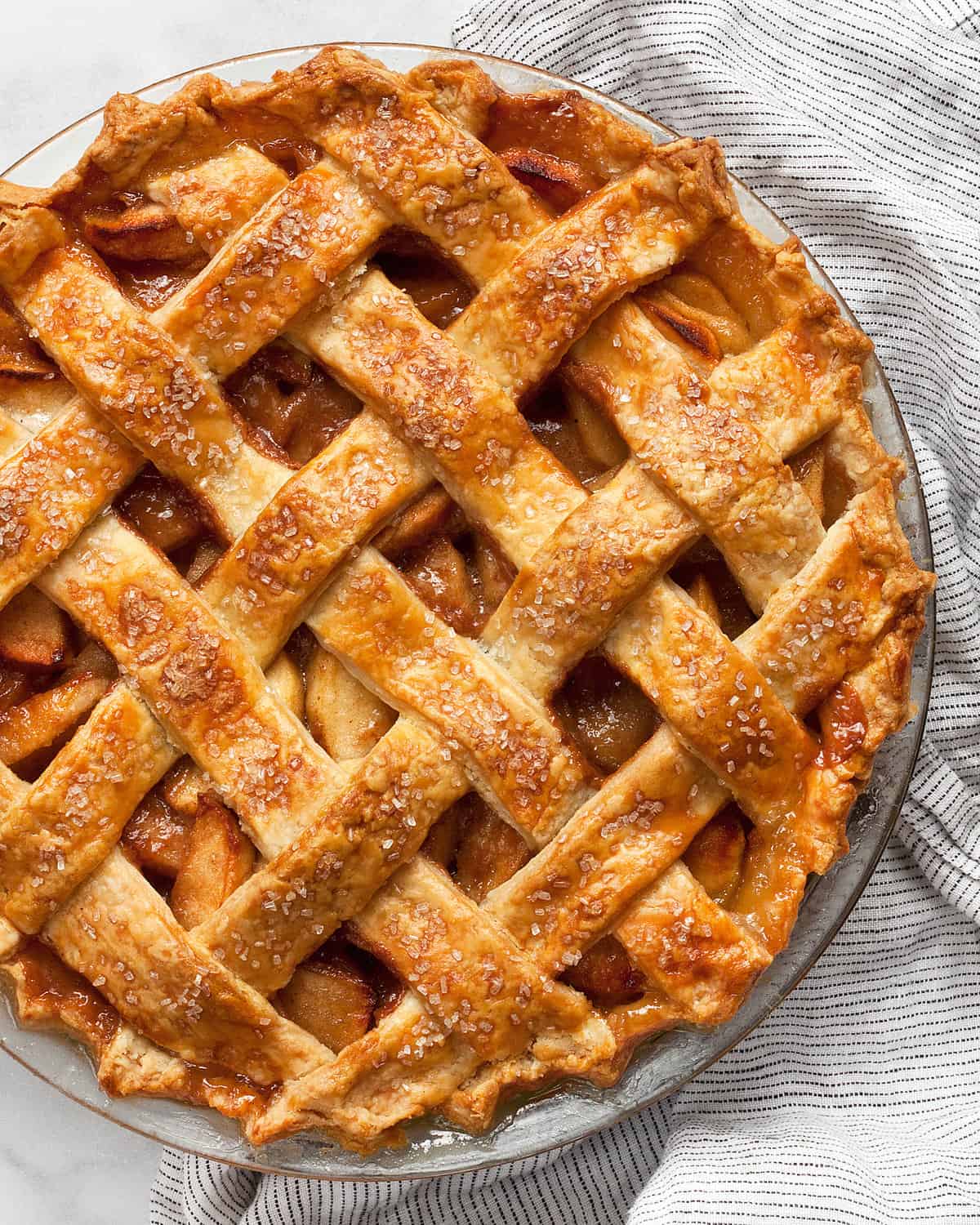 Salted caramel apple pie in a pie dish.