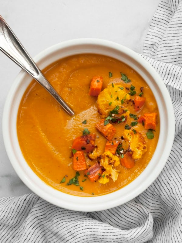 Roasted sweet potato cauliflower soup in a bowl.