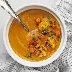Roasted sweet potato cauliflower soup in a bowl.