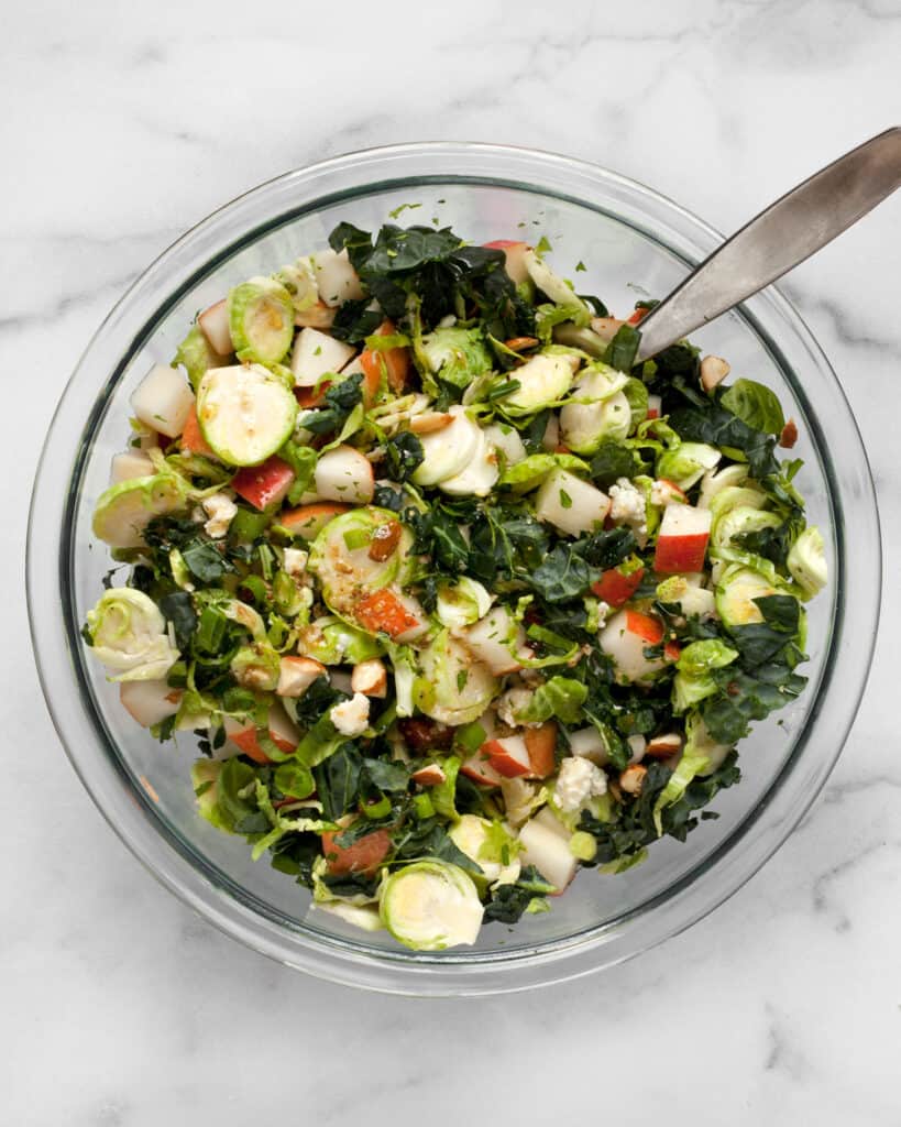 Combine the kale, brussels sprouts and pears in a bowl and stir in the vinaigrette