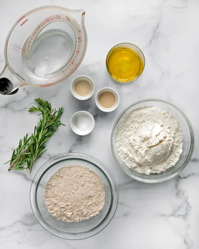 Ingredients including fresh rosemary, bread flour, whole wheat flour, yeast and salt
