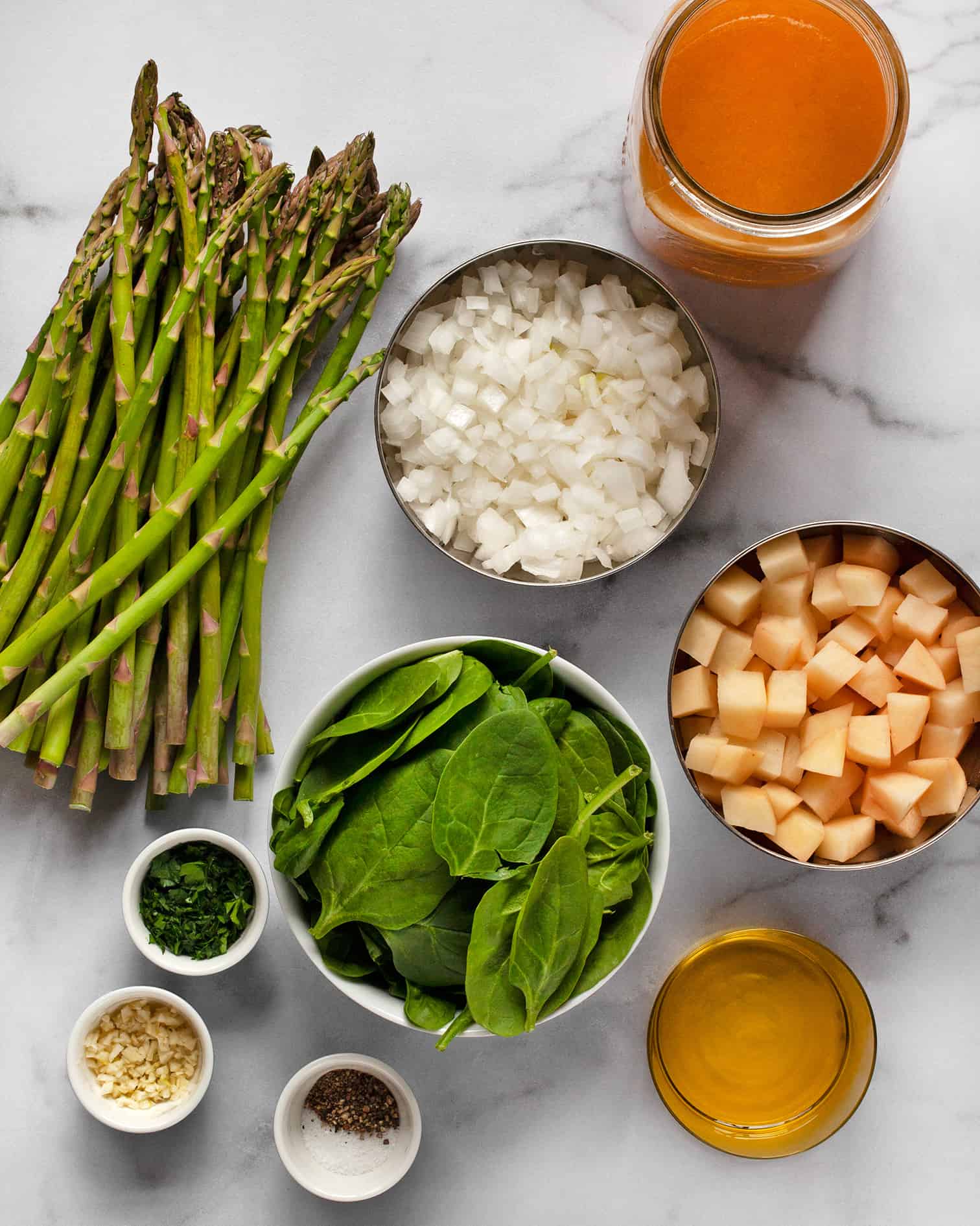 Ingredients including asparagus, spinach, onions, potatoes and vegetable broth.