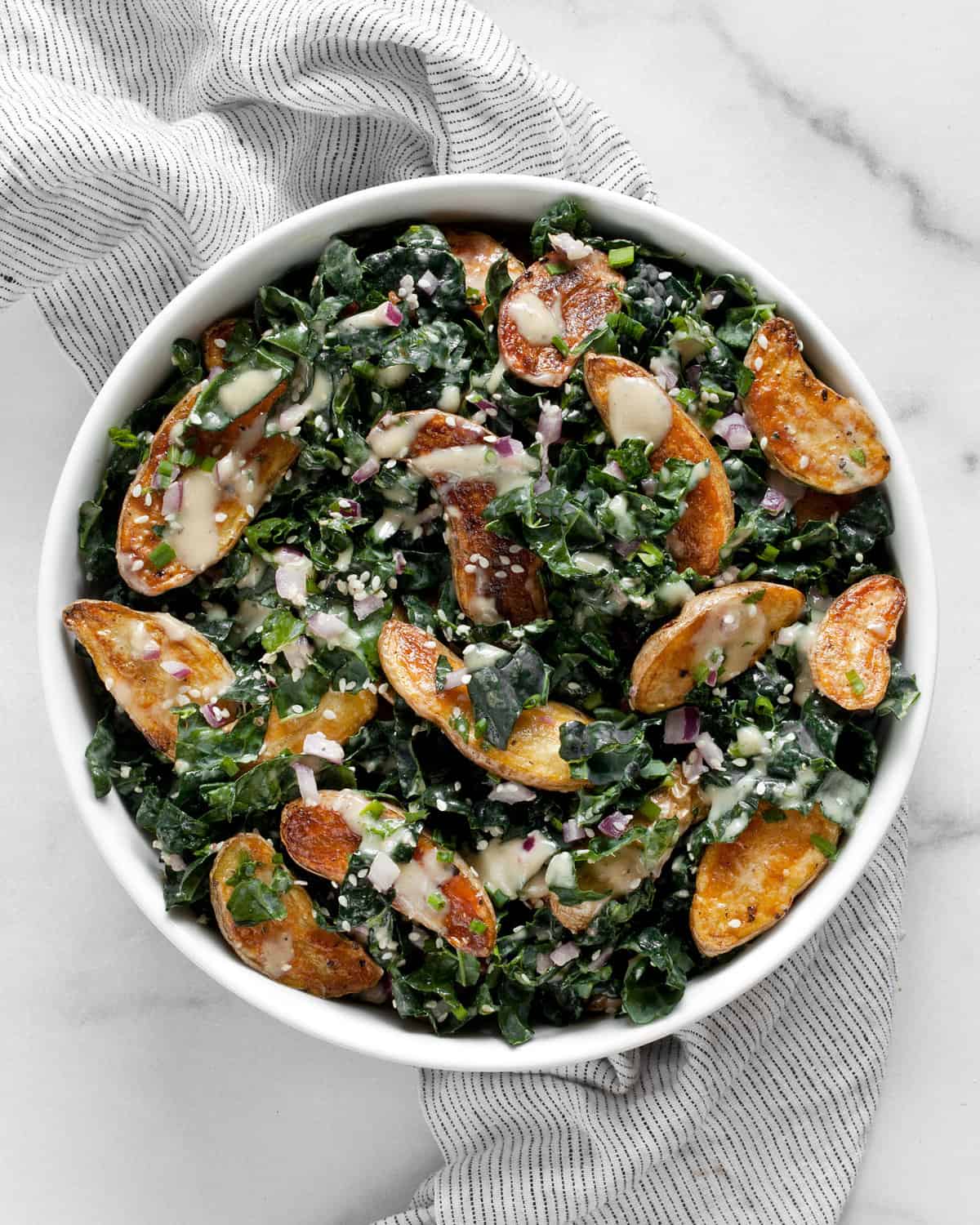 Roasted fingerling potato and kale salad in a bowl.