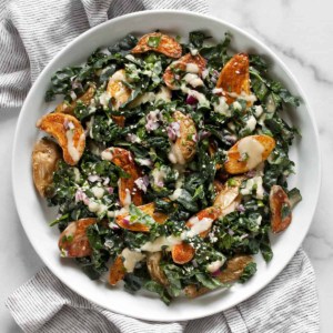 Roasted potato kale salad on a plate.