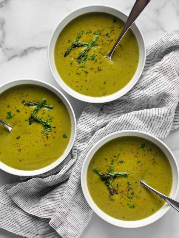 Three bowls of roasted asparagus soup.