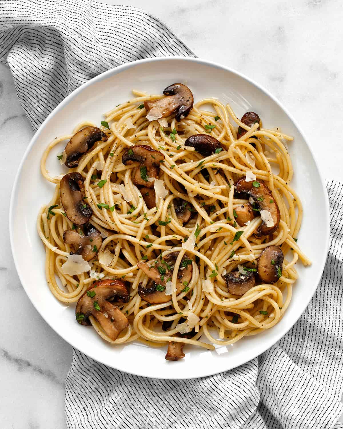 Spaghetti with lemon and mushrooms on a plate.