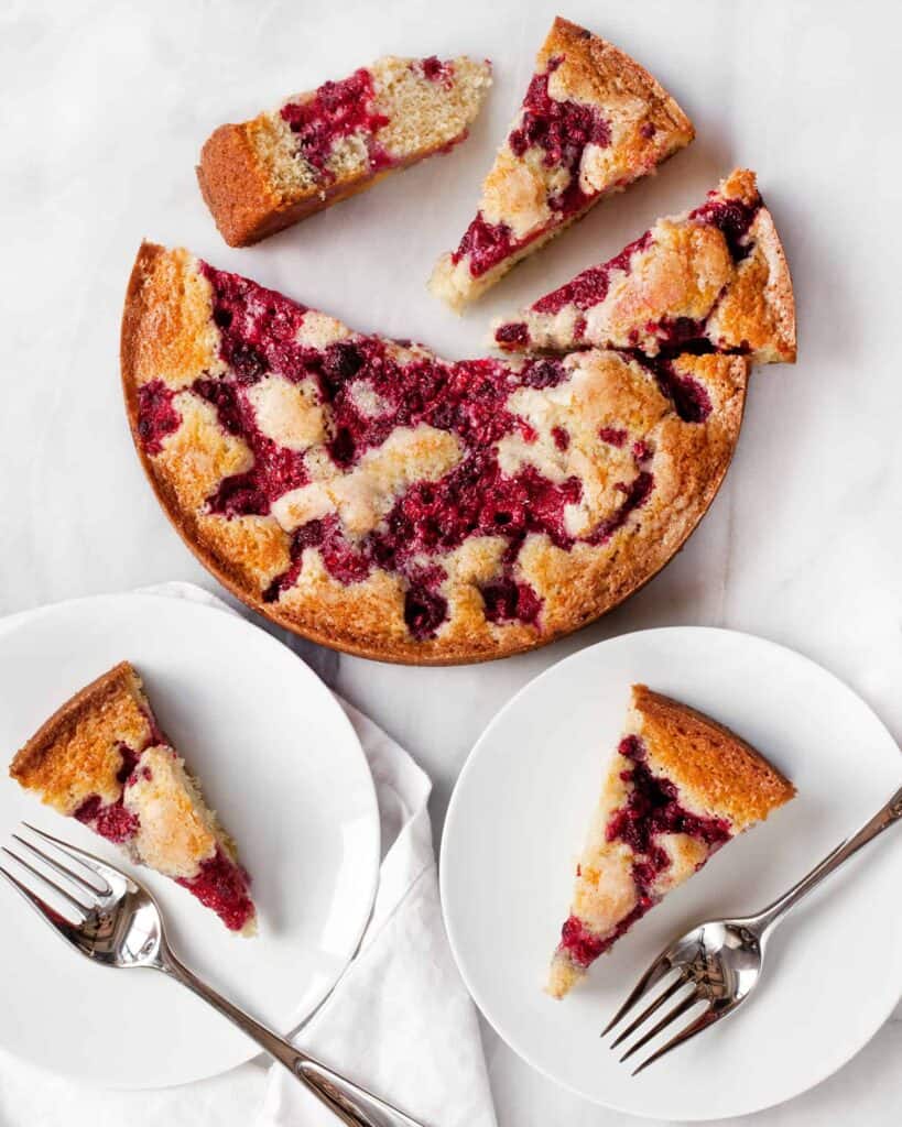 Raspberry buttermilk cake sliced and served on plates