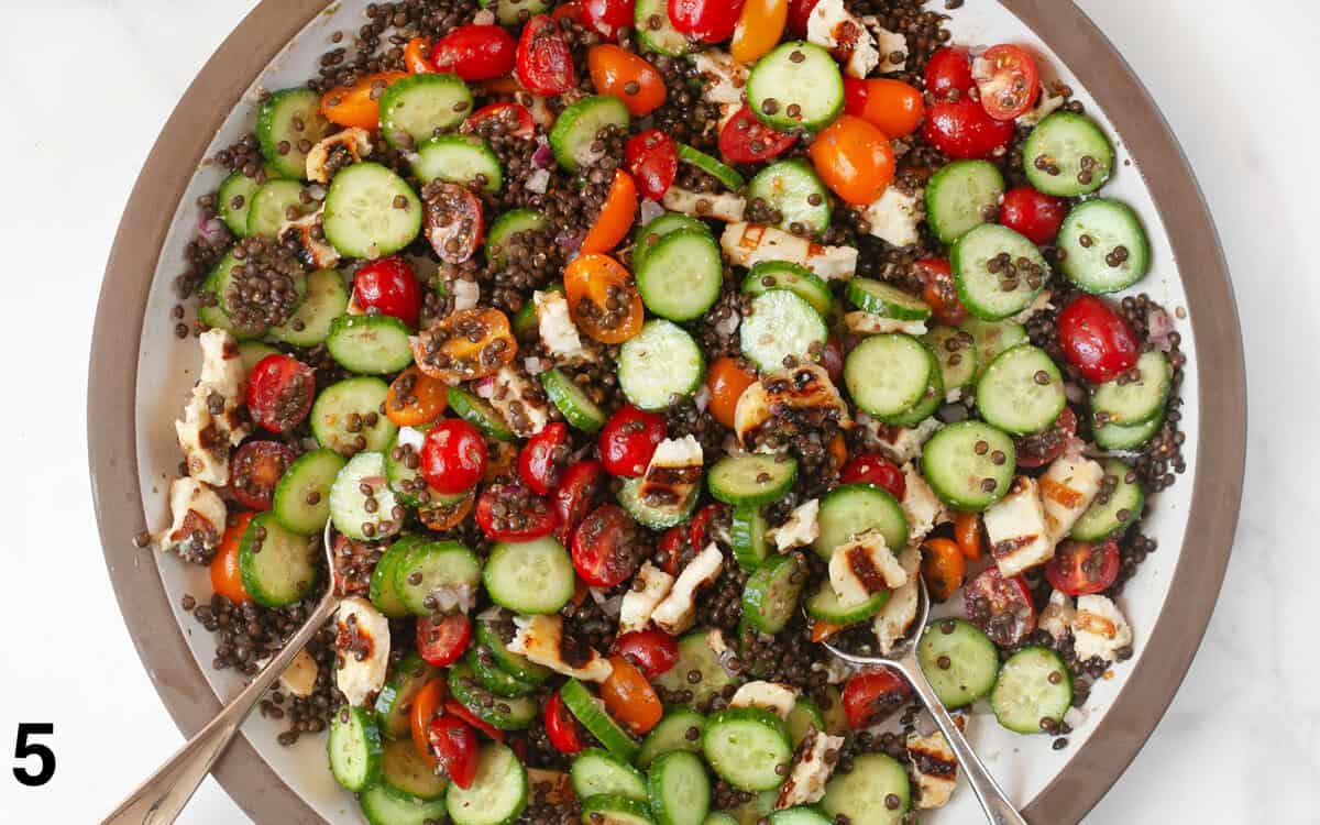 Halloumi salad tossed in a large salad bowl.