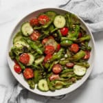 Grilled shishito pepper cucumber salad in a bowl.
