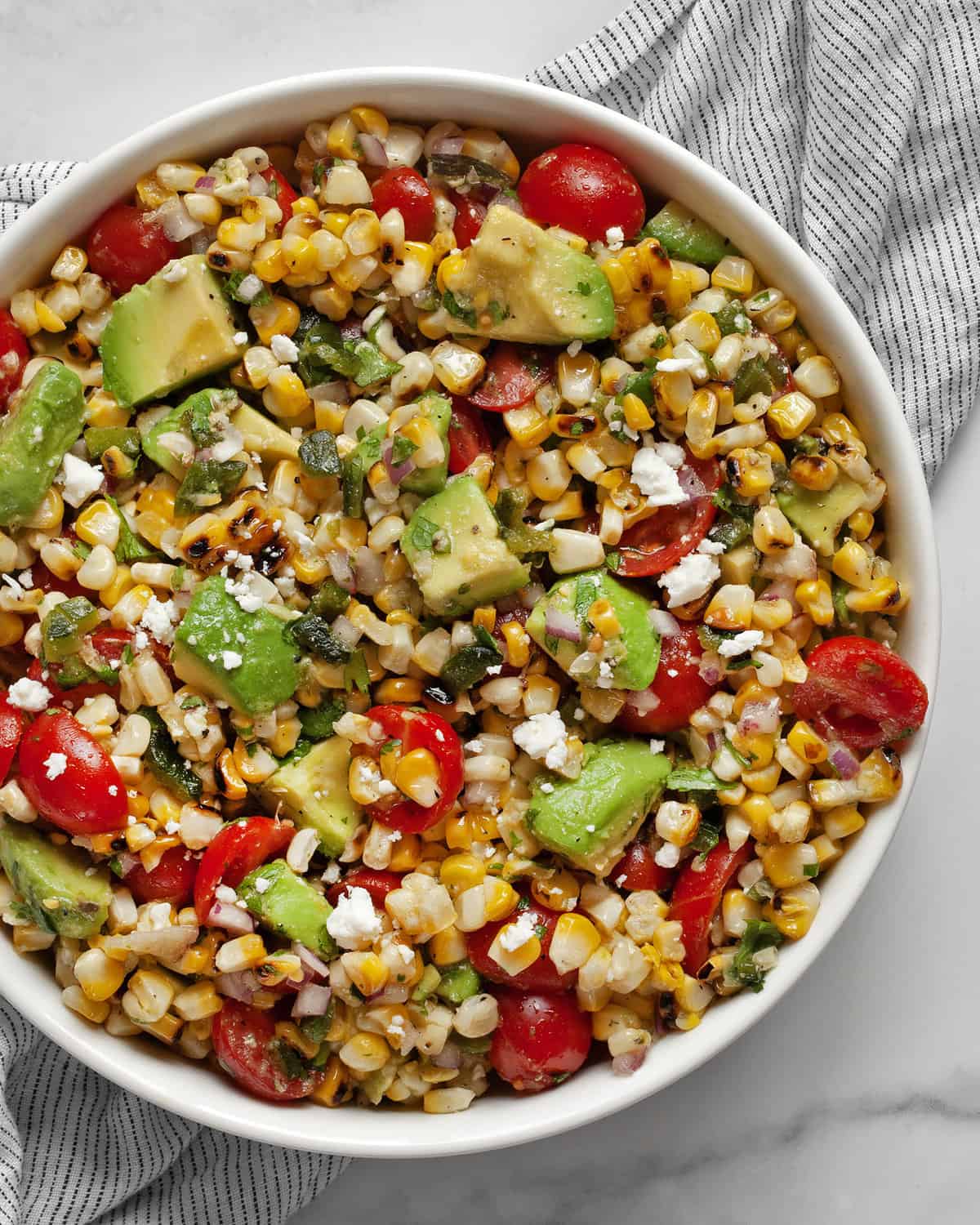 Corn salad with avocados in a bowl.