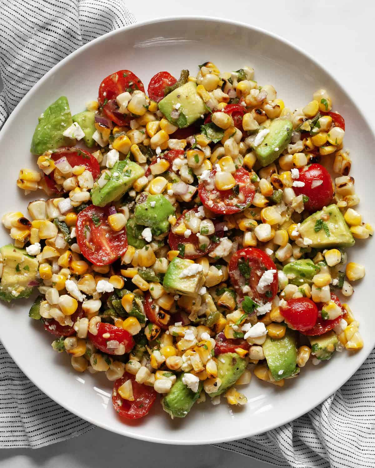 Grilled corn avocado salad in a bowl.