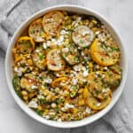 Grilled zucchini, yellow squash and corn in bowl.