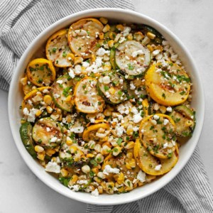 Grilled zucchini, yellow squash and corn in bowl.