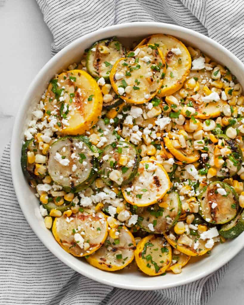 Grilled zucchini, yellow squash and corn in bowl.