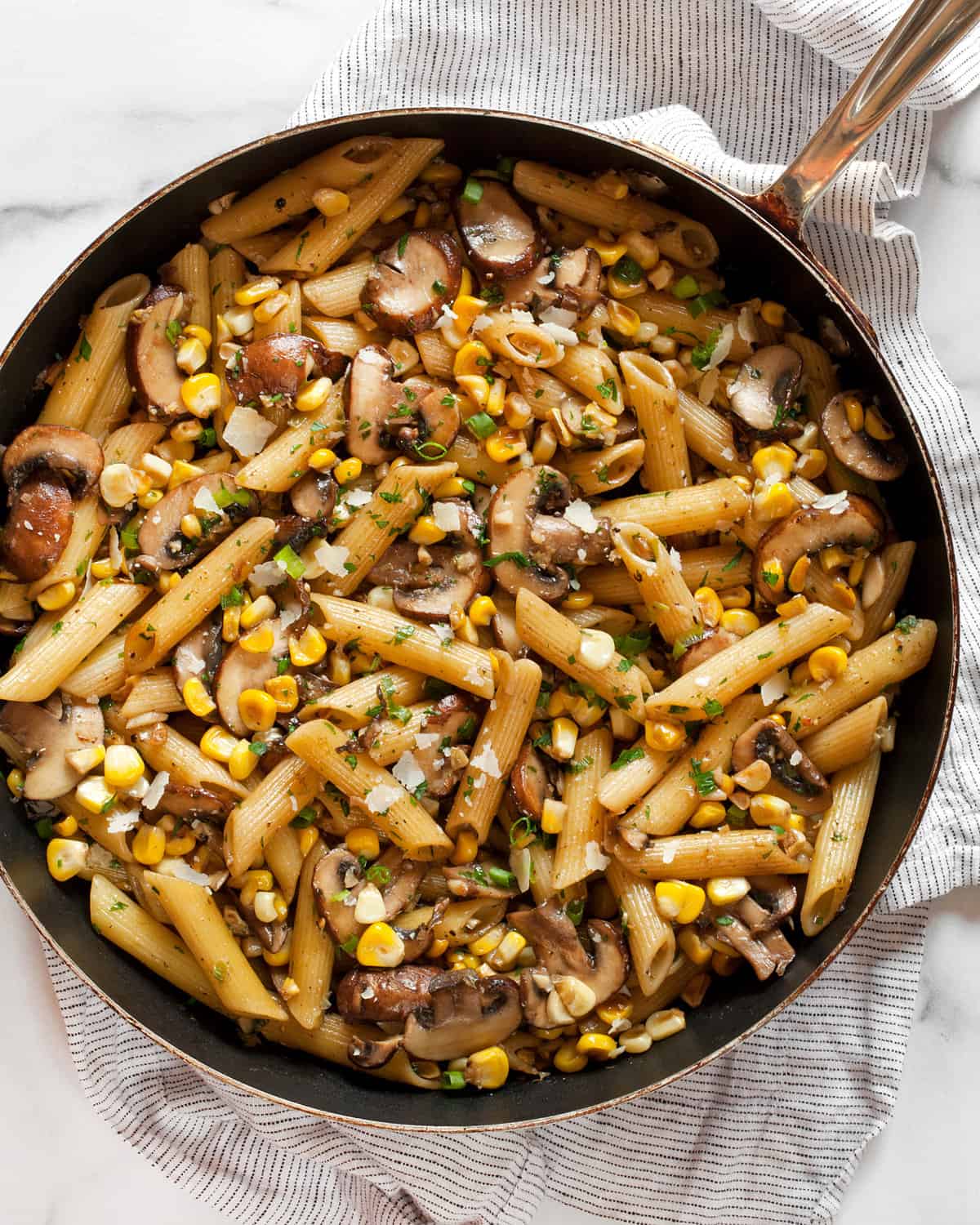 Mushroom corn pasta in a skillet.