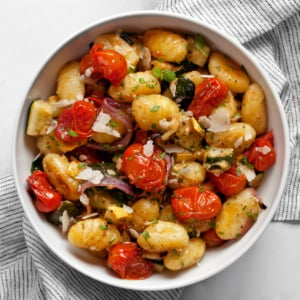 Sheet pan gnocchi with roasted vegetables in a bowl.