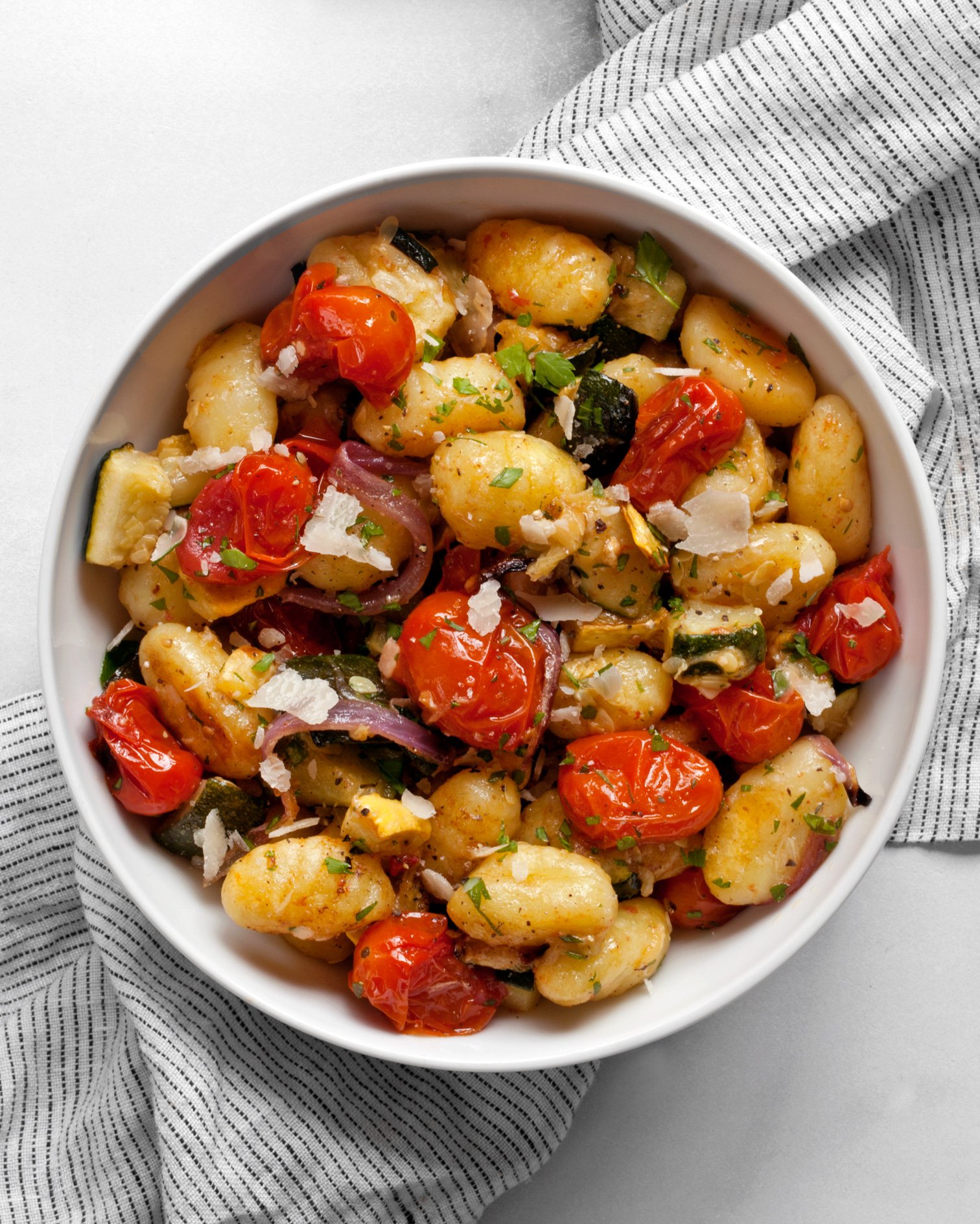 Sheet pan gnocchi with roasted vegetables in a bowl.