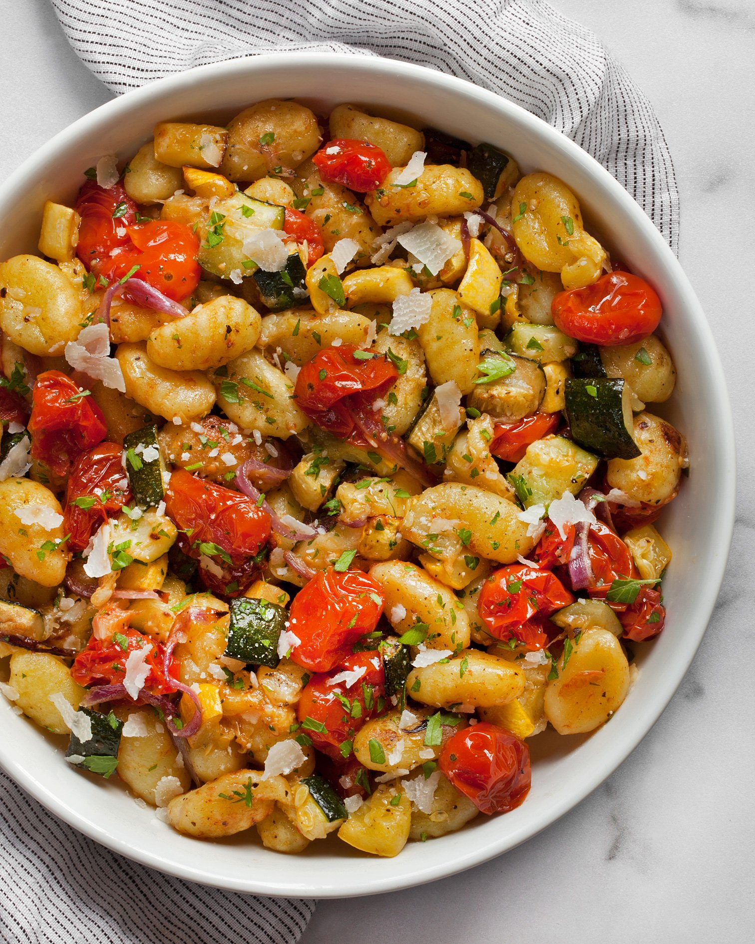 Sheet pan gnocchi with roasted vegetables in a bowl.