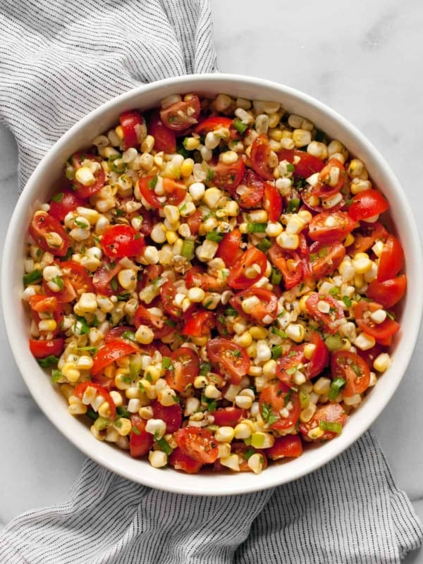 Fresh corn and tomato salad in a bowl.