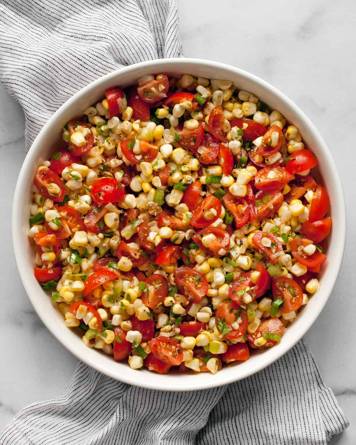 Fresh corn and tomato salad in a bowl.