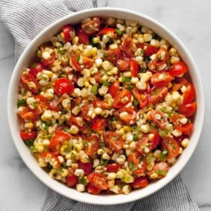 Fresh corn and tomato salad in a bowl.