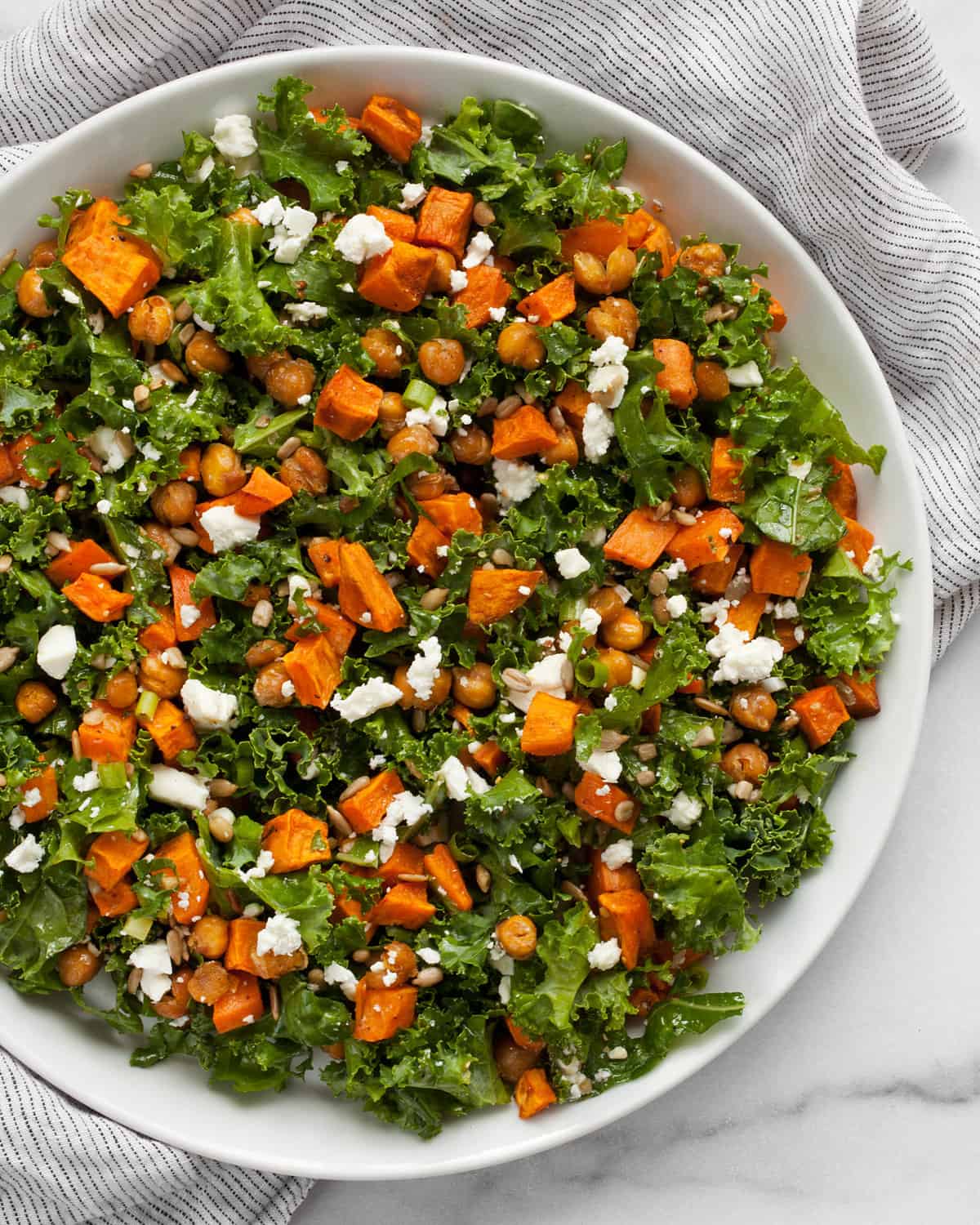 Sweet potato and chickpea kale salad on a plate.