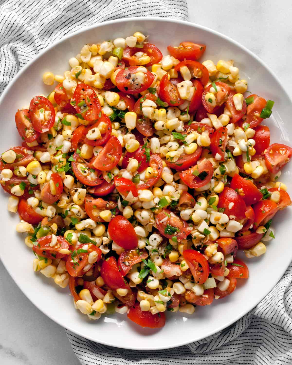 Close-up of tomato corn salad on a plate.