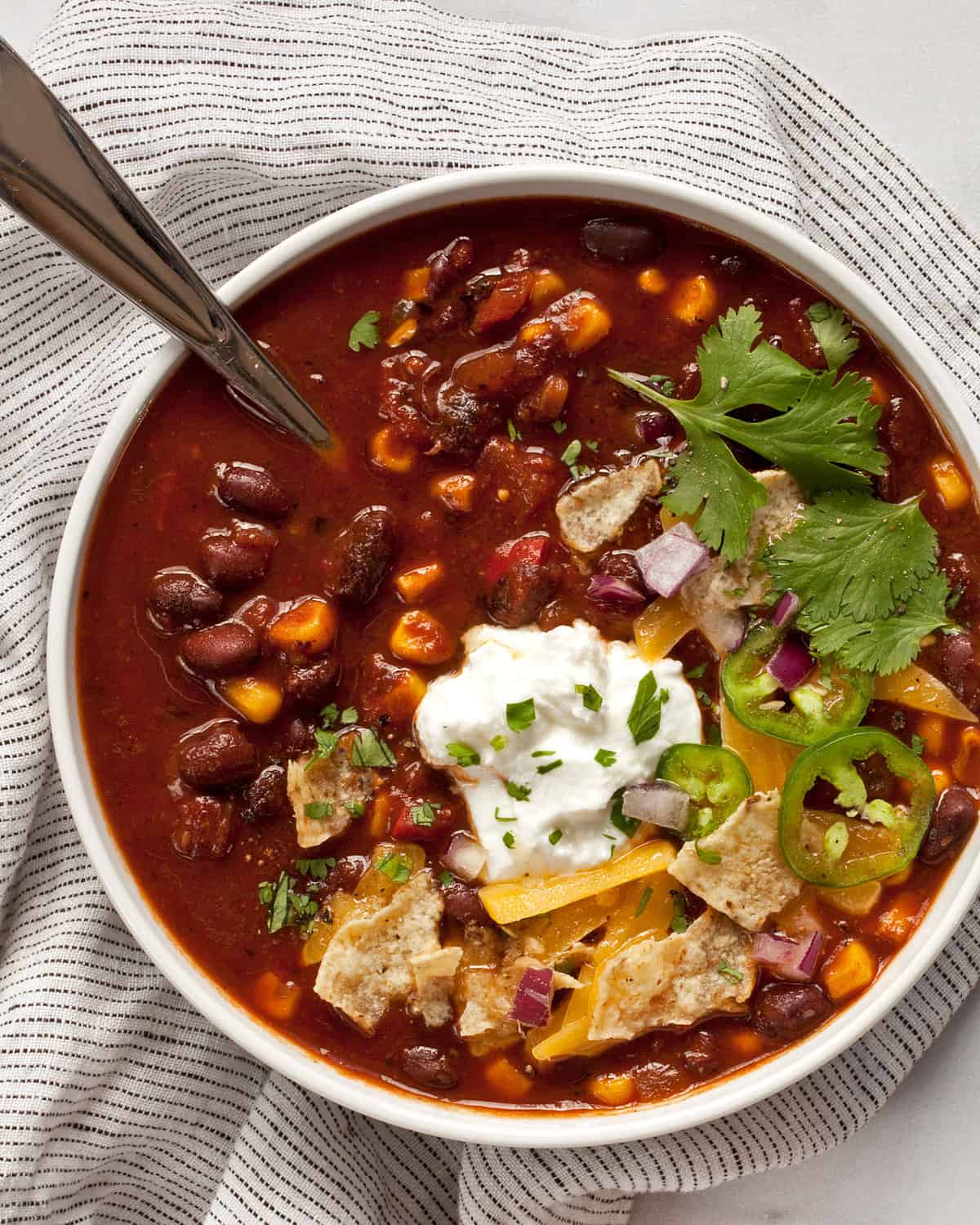 Bowl of chili with black beans, corn and tomatoes.