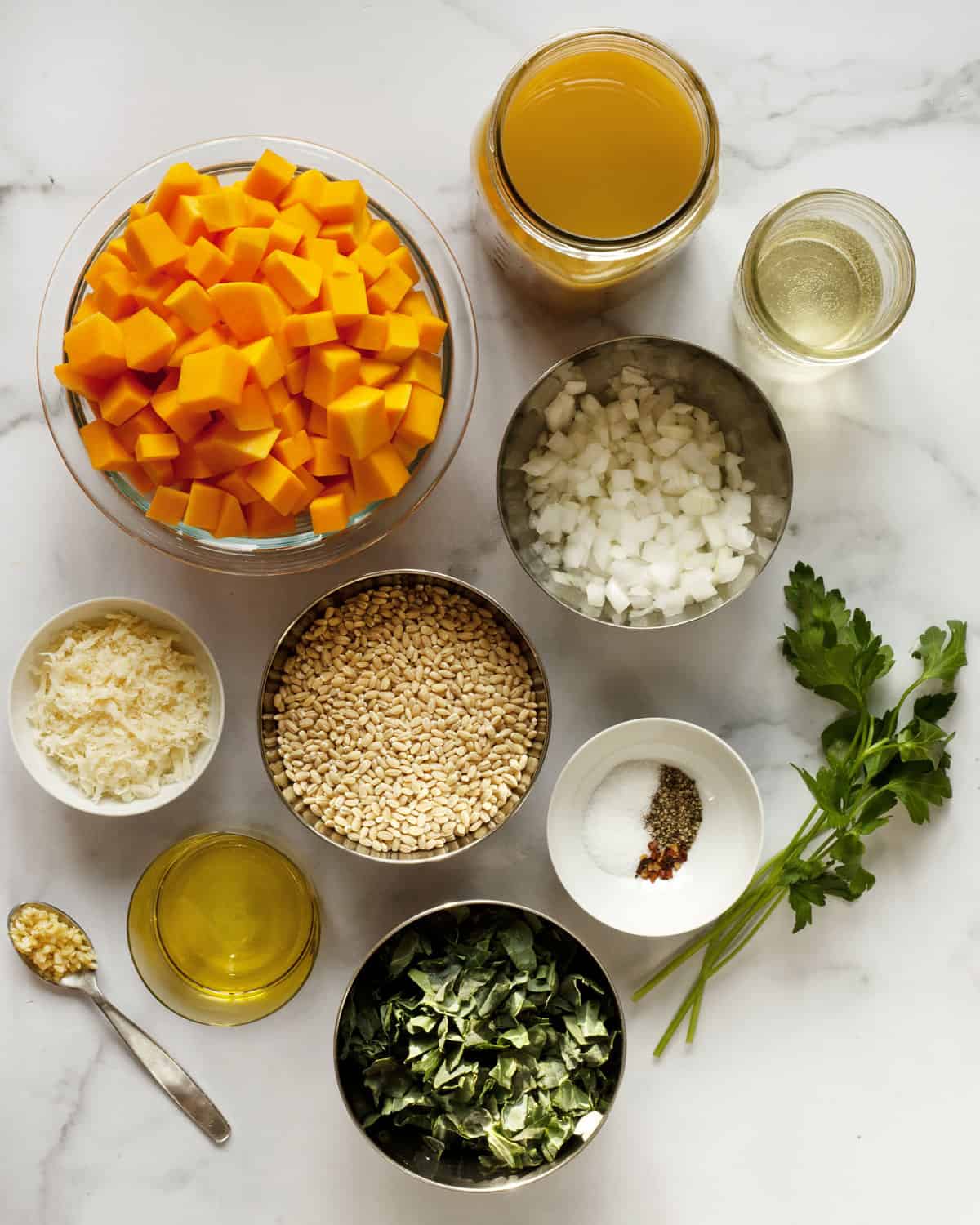 Ingredients including barley, butternut squash, onions, veggie broth, spices, kale, olive oil, garlic and parmesan.