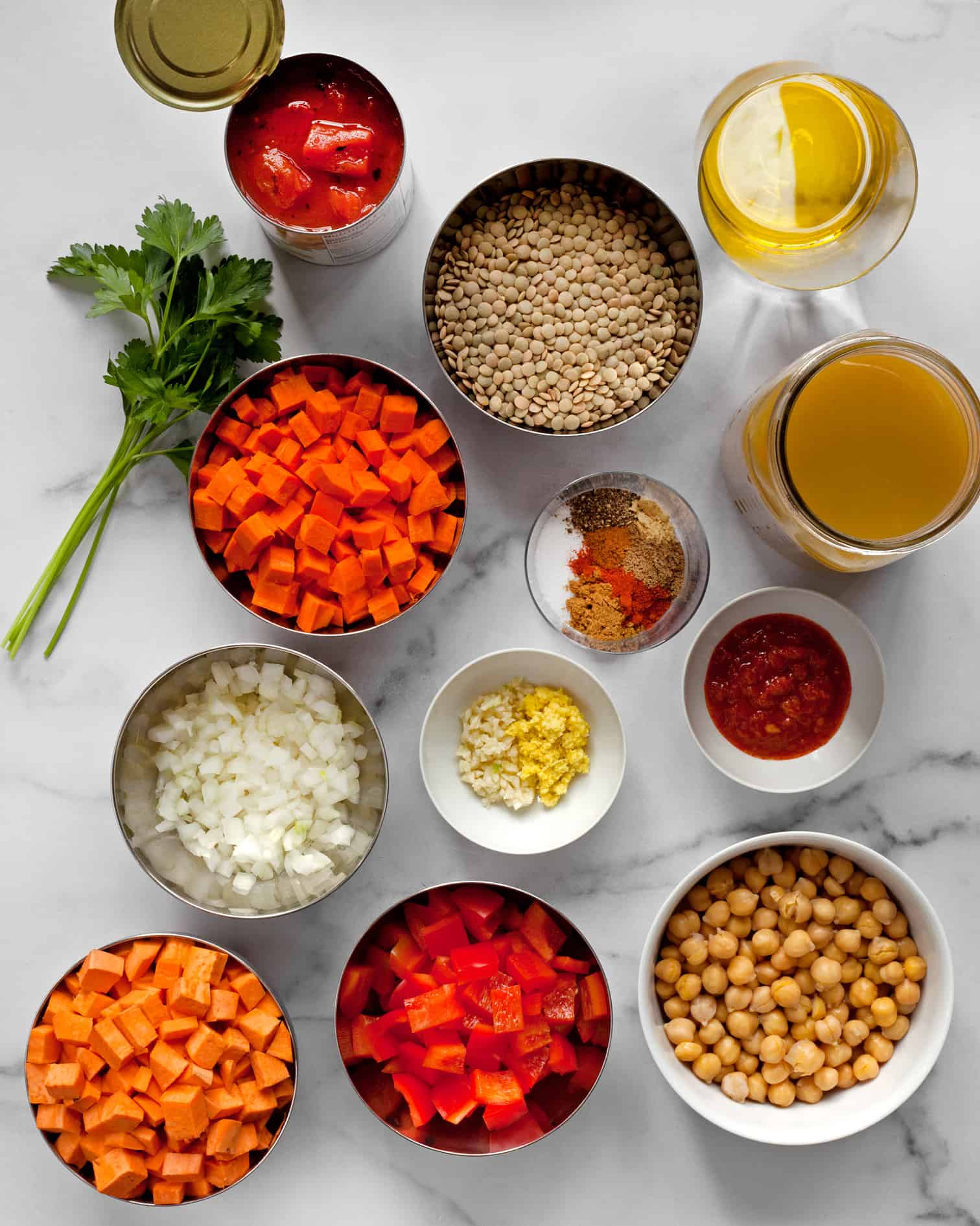 Ingredients including chickpeas, sweet potatoes, peppers, lentils, chickpeas and tomatoes