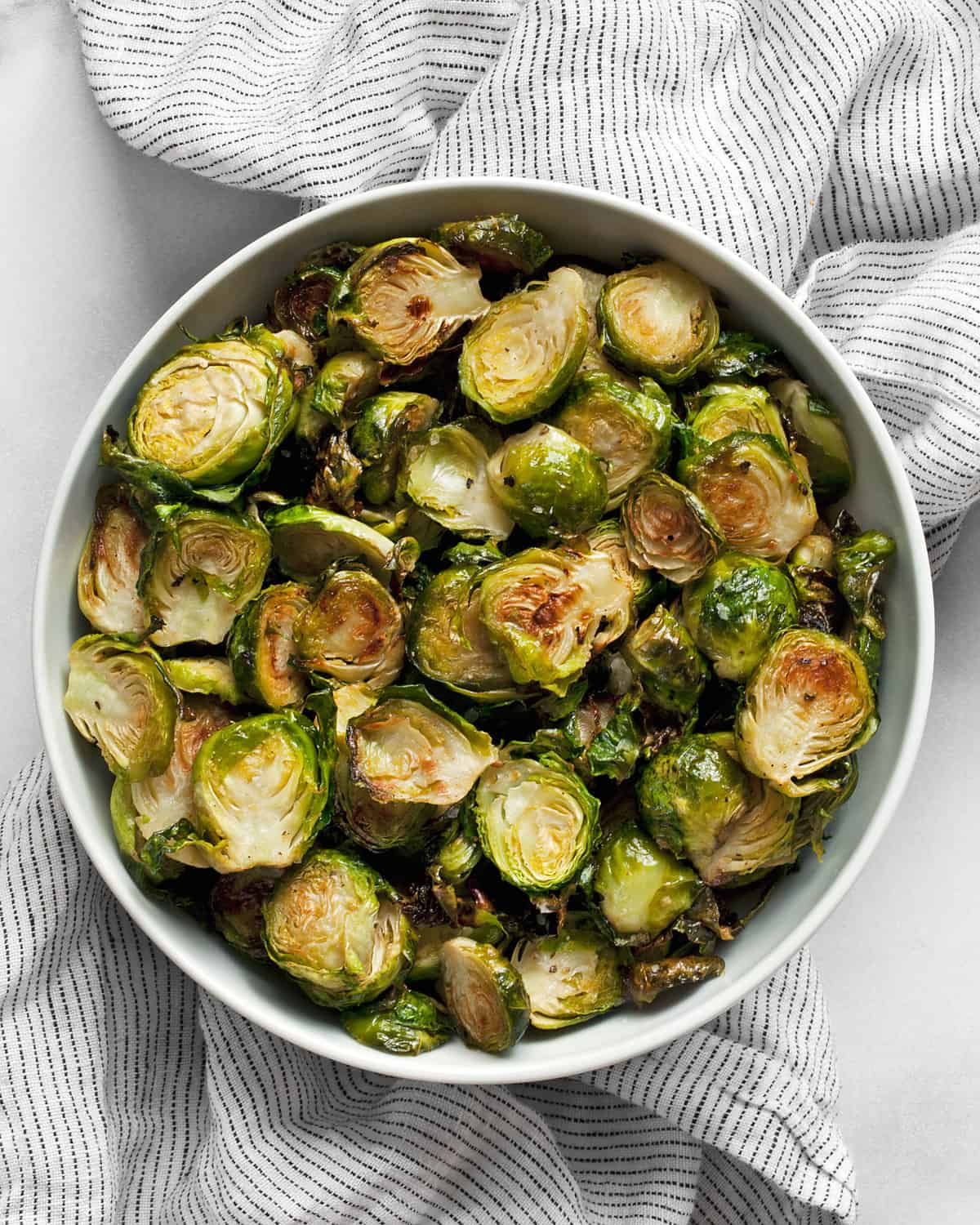 Thinly sliced crispy roasted brussels sprouts in a bowl.