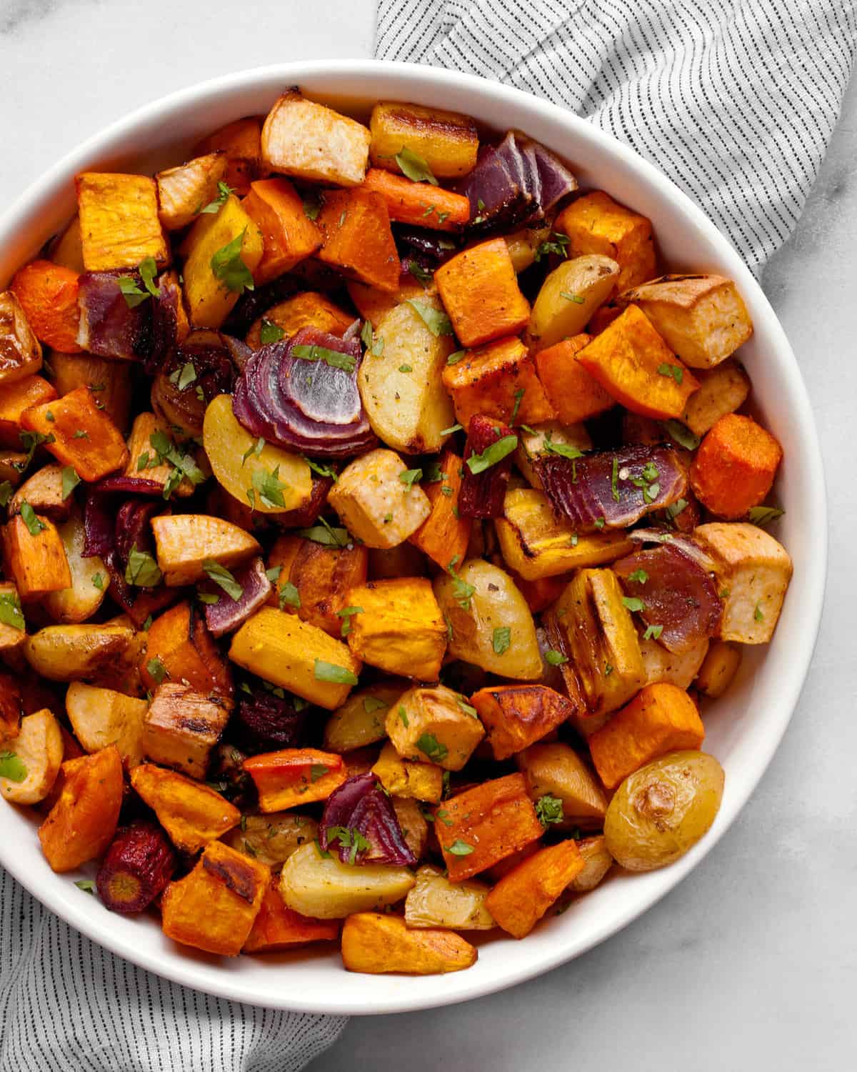 Assorted roasted vegetables in a bowl.