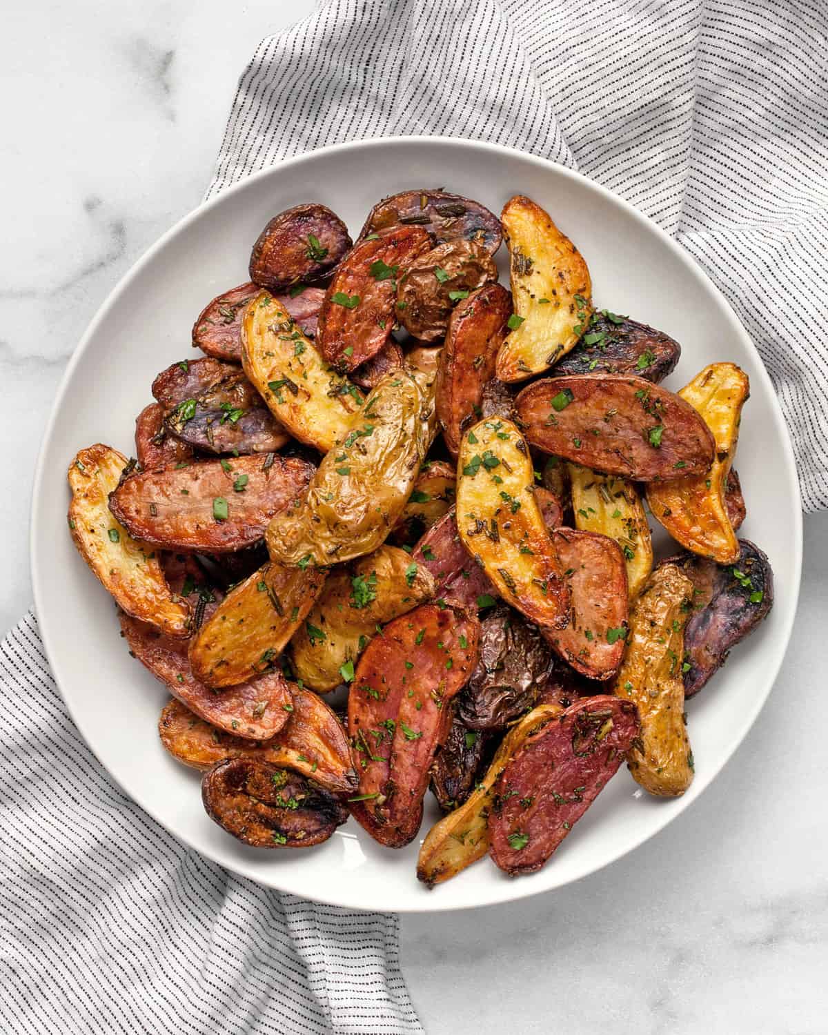 Roasted rosemary potatoes on a plate.