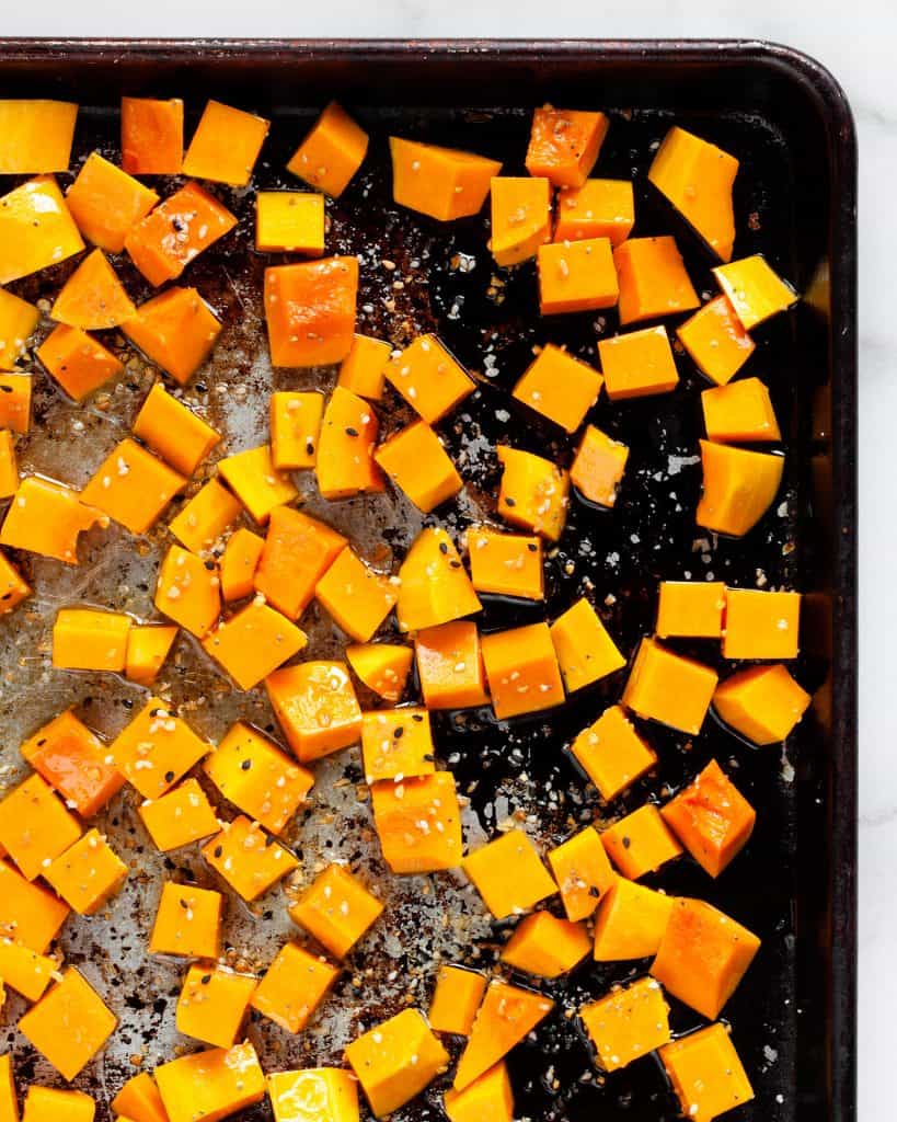 Diced butternut squash on a sheet pan