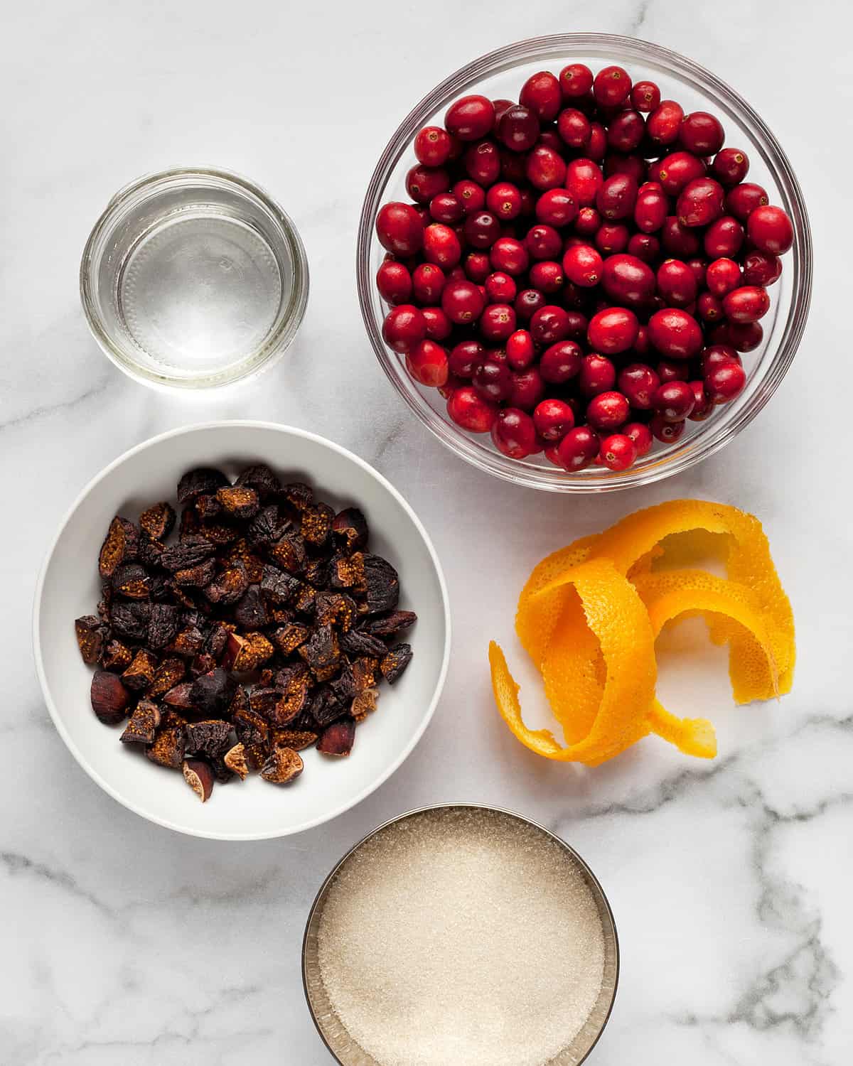 Ingredients including fresh cranberries, orange zest, sugar, figs and water.