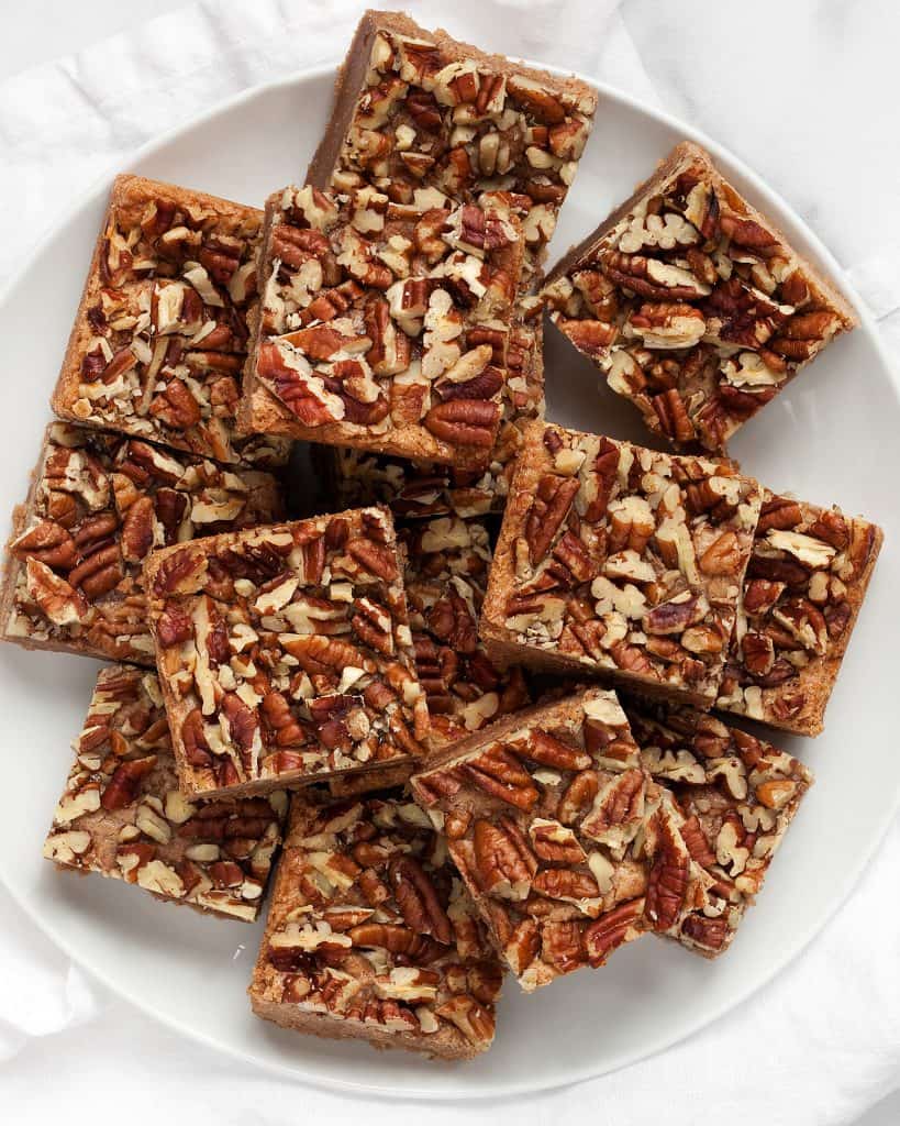 Pecan topped cinnamon squares on a plate