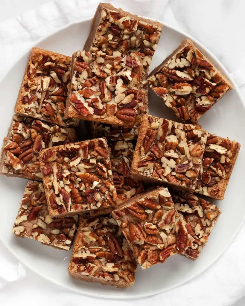 Pecan topped cinnamon squares on a plate