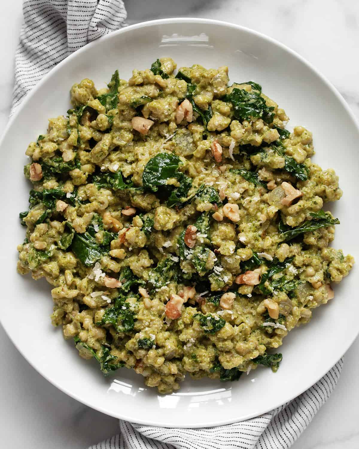 Baked kale barley risotto on a plate.