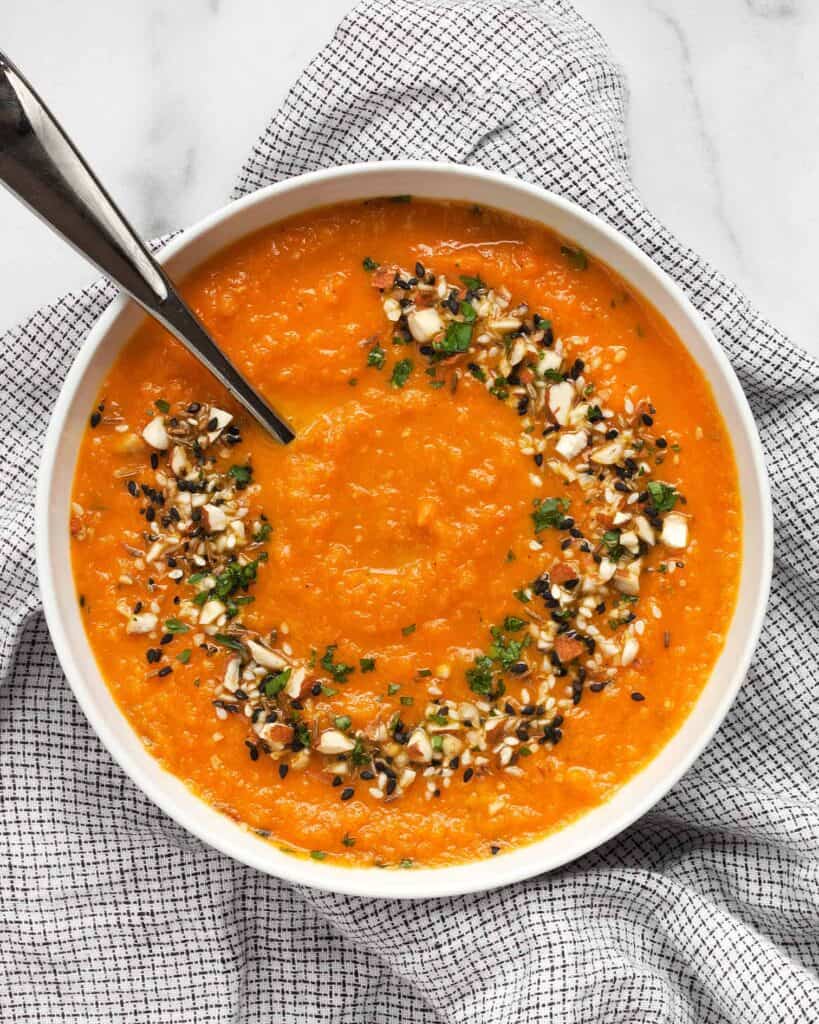 Vegan carrot soup topped with dukkah spice mix