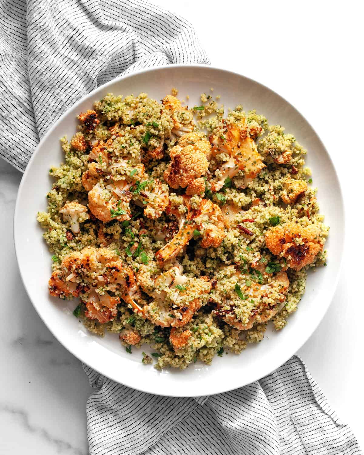 Harissa roasted cauliflower couscous on a plate.