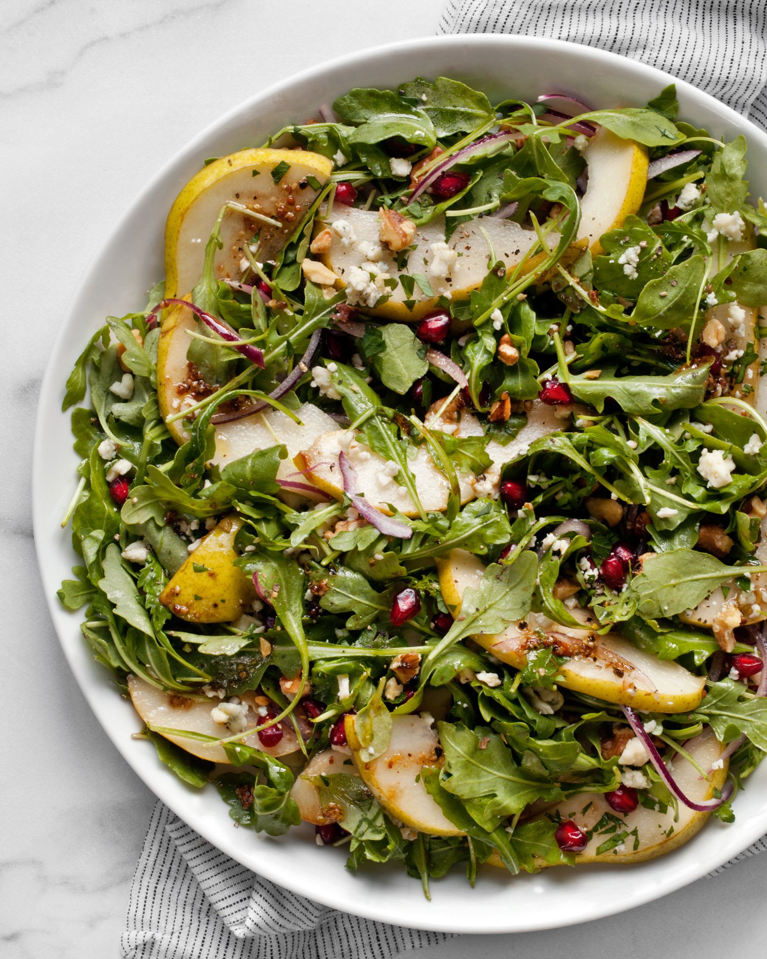 Pear gorgonzola salad on a plate.