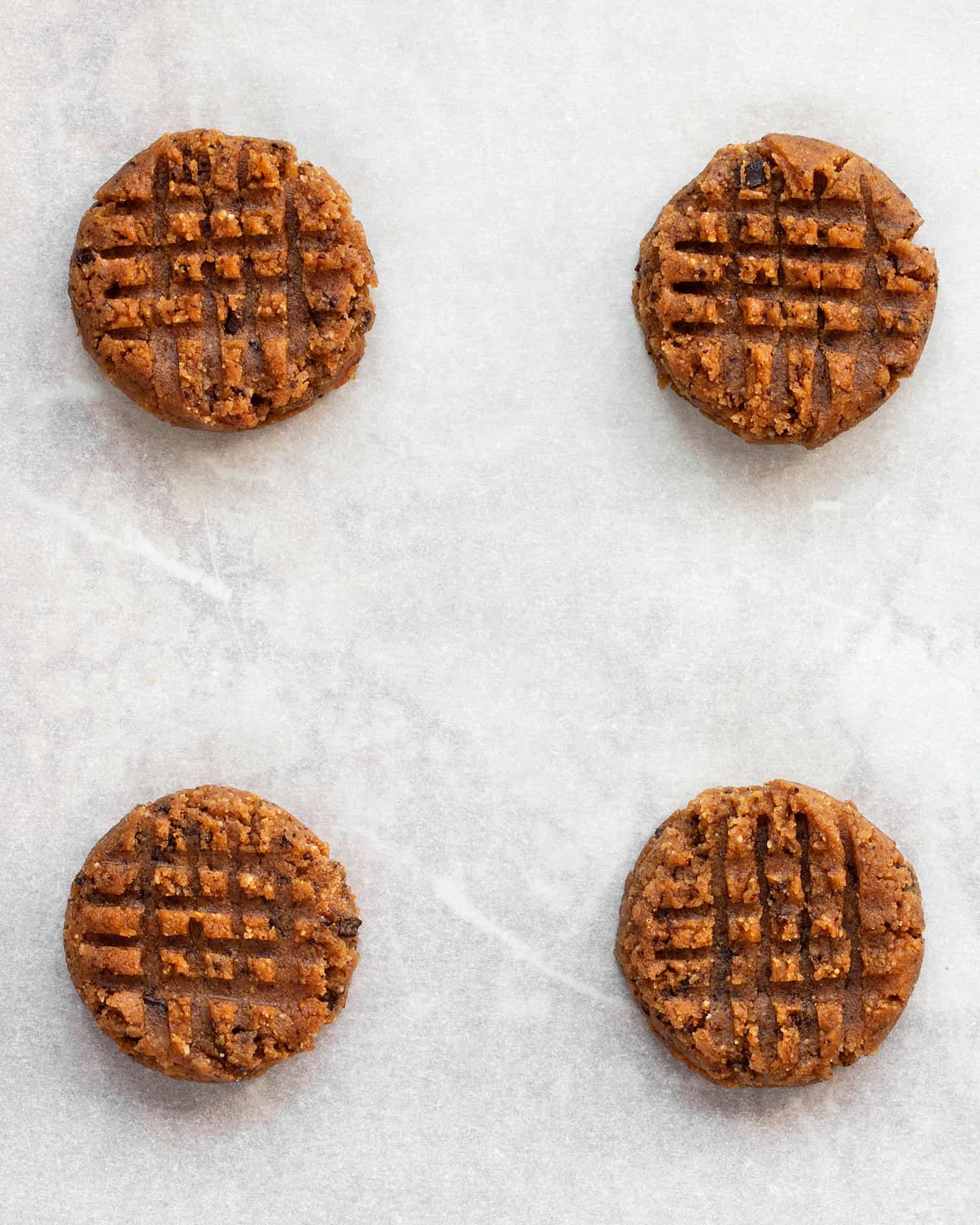 Peanut butter cookie dough shaped with crosshatch on top